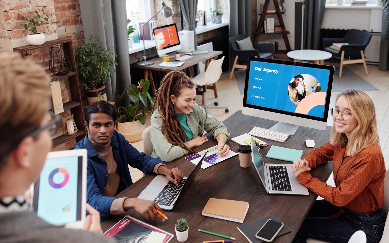 An agency team reviewing client work around a shared screen